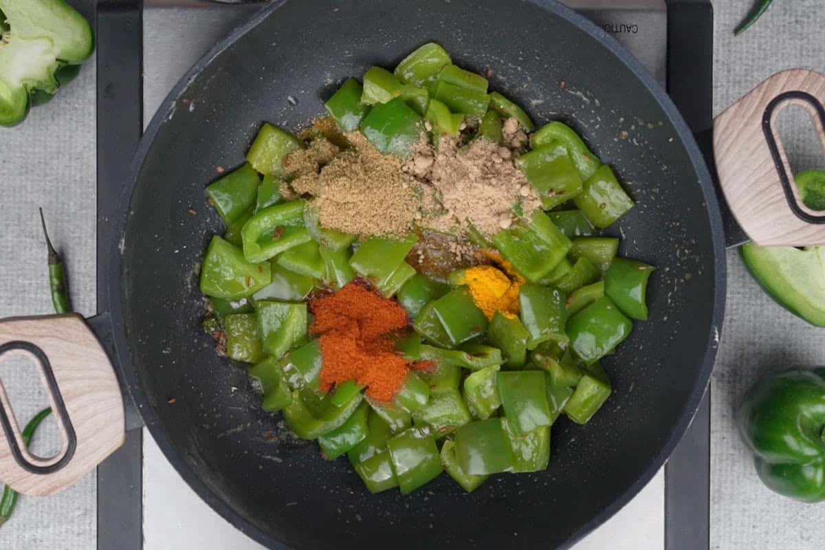 Spice powders added to the pan.