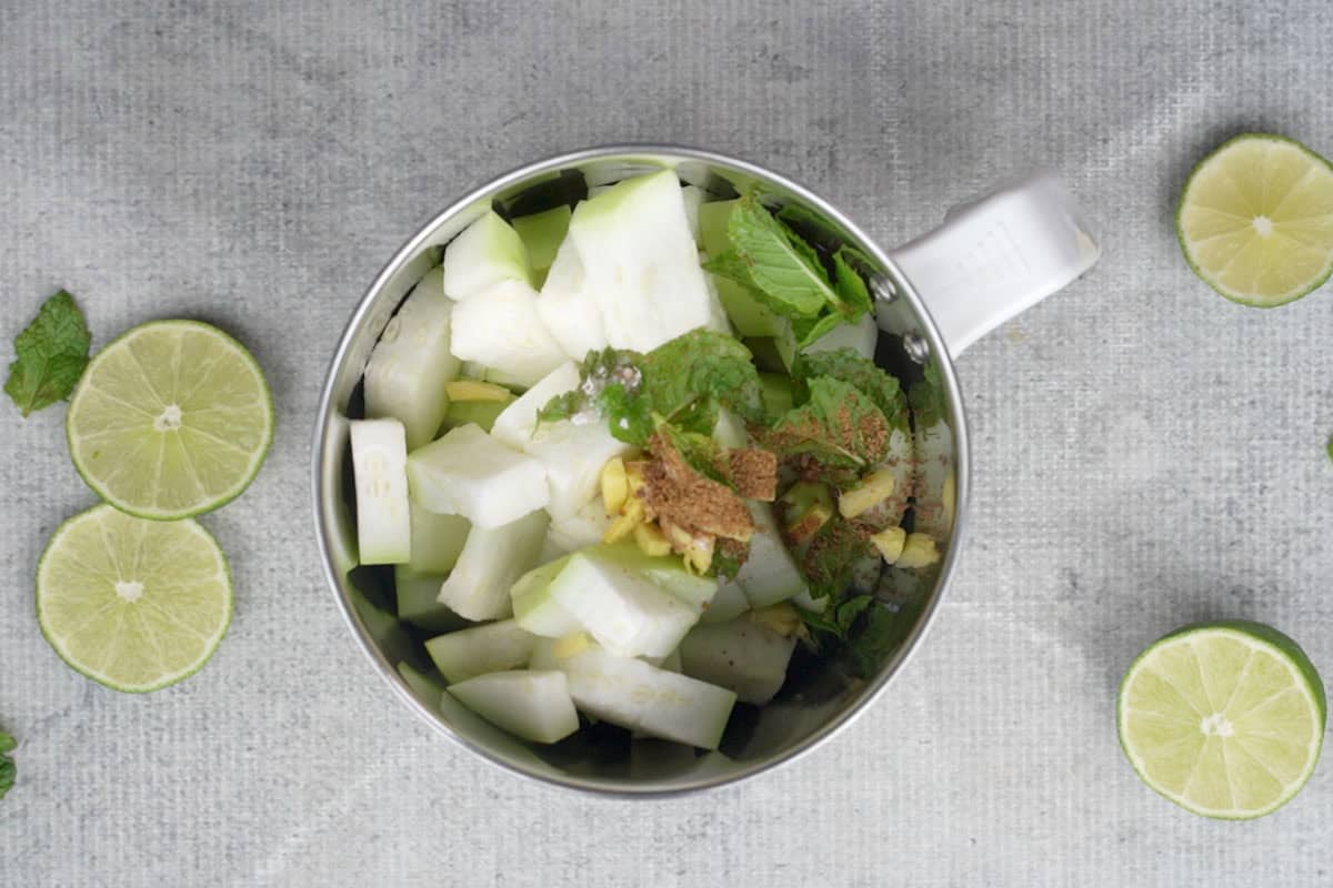 All the juice ingredients added to the jar of a blender.