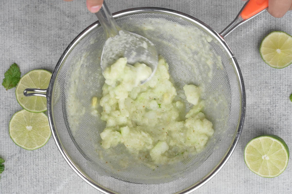 Passing the mixture through a fine mesh strainer.