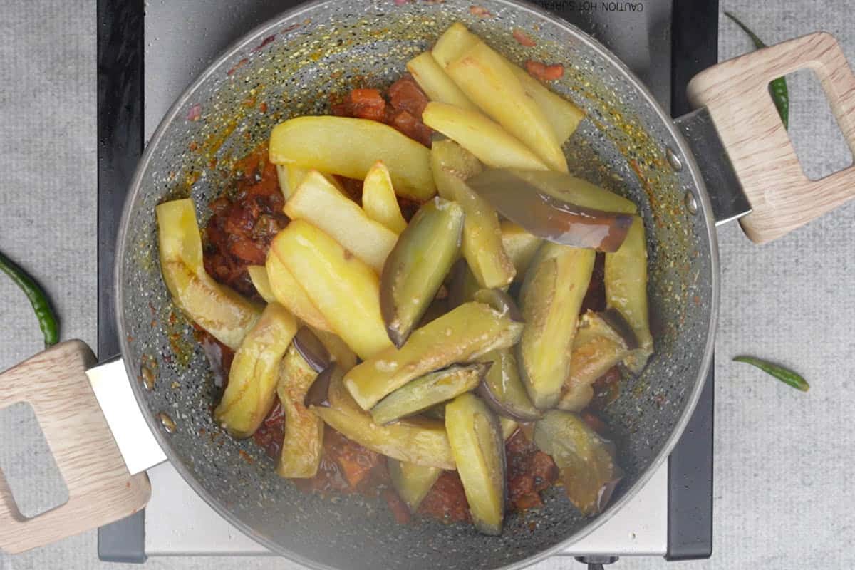 Fried potatoes and eggplant added to the pan.