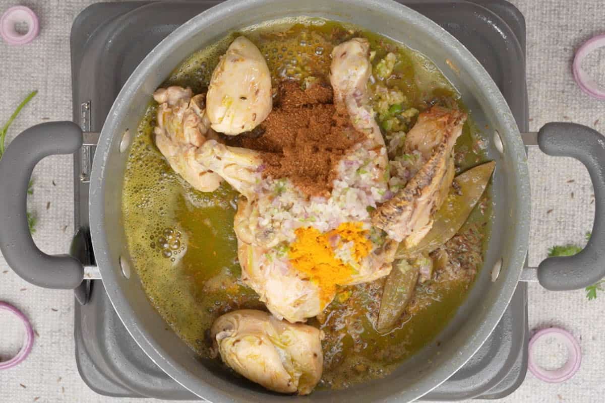 Onion paste, salt, turmeric powder, garam masala added to the pan.